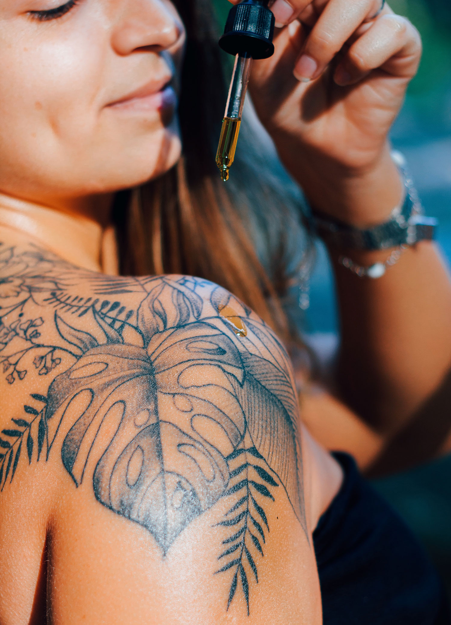 Shoulder tattoo with drop of essential oil
